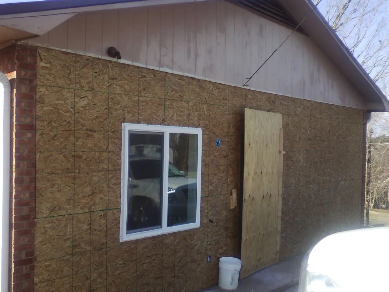 OSB sheathing on a garage addition wall before siding in Greensboro